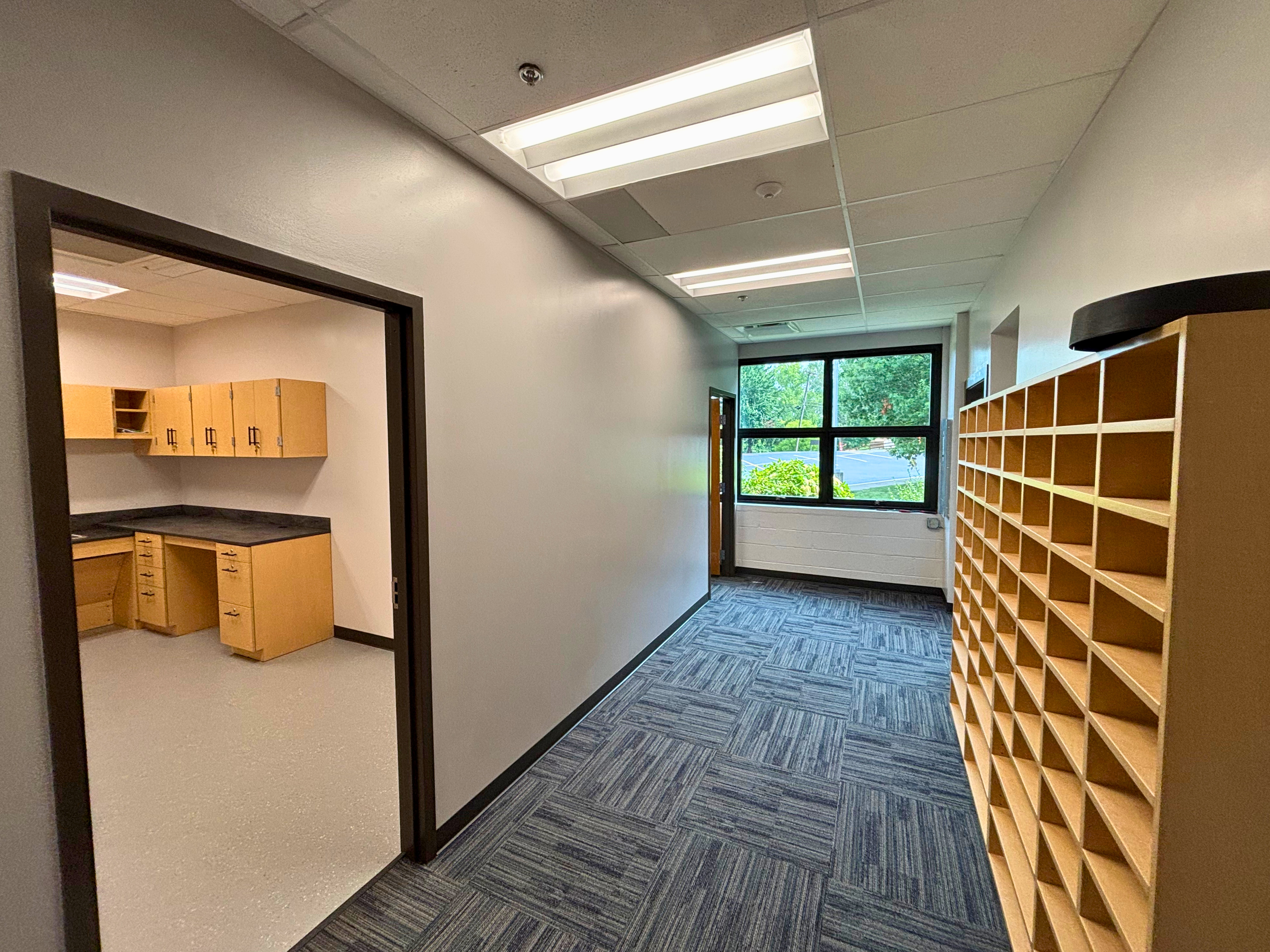 New entry hallway — partitions, doors, and finishes patched into the existing building