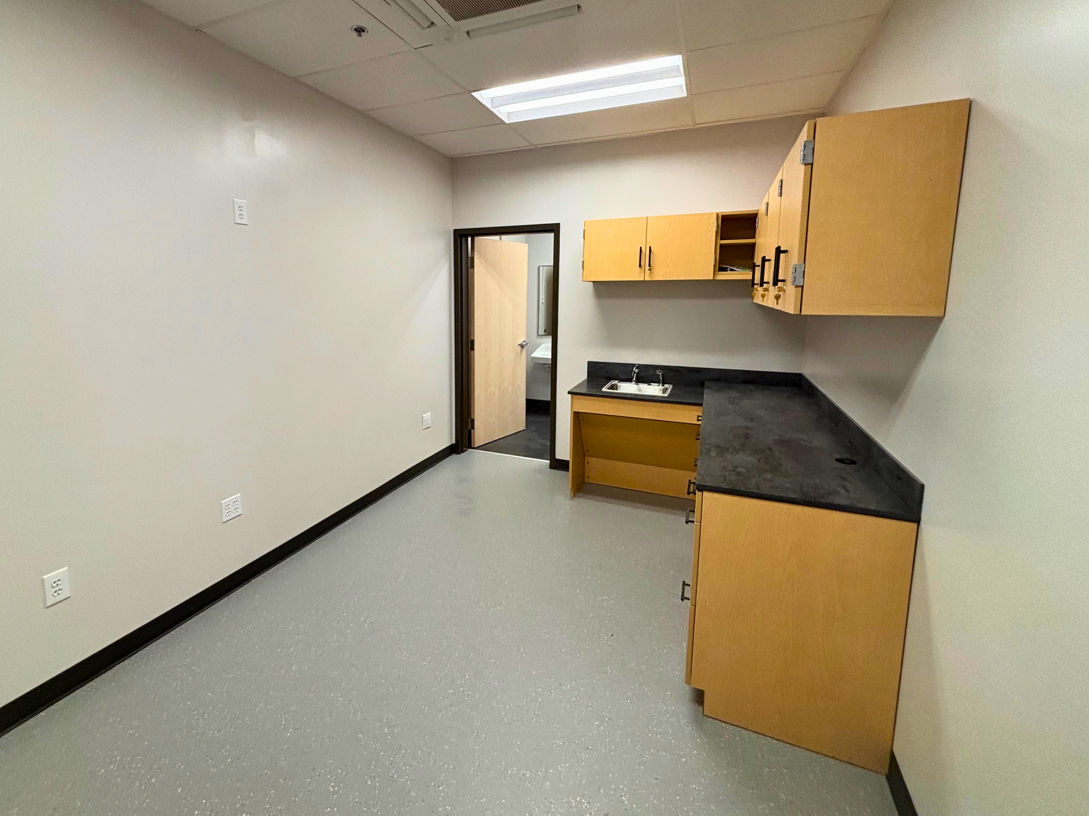 New first-aid room with solid-surface casework and ADA sink